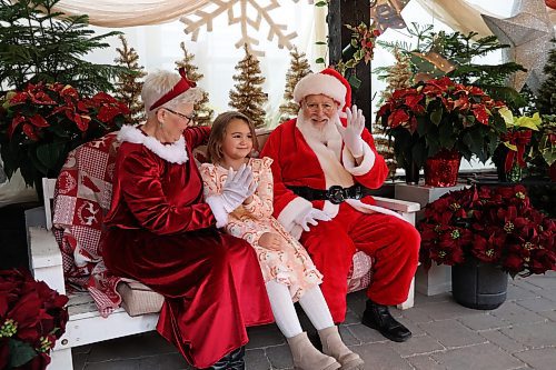 Amelia Girard (Middle) poses for a picture with Santa and Mrs Claus at the Alternative Families Choice Garden Centre on Saturday afternoon. Alternative Gardens opened its doors for families looking for a festive way to kick off the holiday season on Saturday for a special Santa and Mrs. Claus event. (Abiola Odutola/The Brandon Sun)