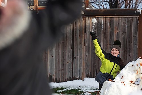 Amara Reichert fires a snowball at her brother Harvey on Monday. (Photos by Tim Smith/The Brandon Sun)