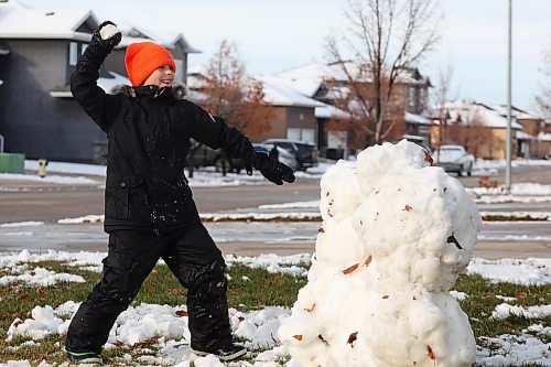 18112024
Harvey Reichert, nine, throws a snowball while enjoying a snowball fight with his sister, Amara, on Monday after Brandon&#x2019;s first snowfall on the weekend. The siblings built snow forts as well before their battle. Brandon is currently under a winter storm watch for Tuesday extending into Wednesday. 
(Tim Smith/The Brandon Sun)