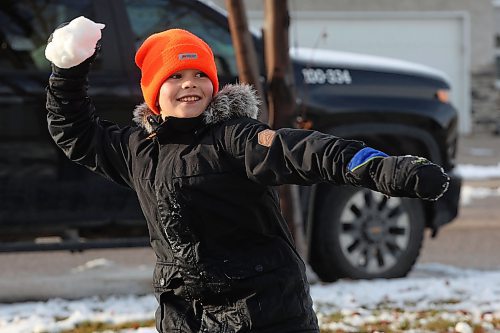 18112024
Harvey Reichert, nine, throws a snowball while enjoying a snowball fight with his sister, Amara, on Monday after Brandon&#x2019;s first snowfall on the weekend. Brandon is currently under a winter storm watch for Tuesday extending into Wednesday. 
(Tim Smith/The Brandon Sun)