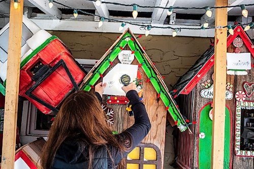 MIKAELA MACKENZIE / FREE PRESS
	
Jen de Delley unboards her Christmas elf village in her carport workshop in River Heights on Monday, Nov. 18, 2024.

For AV story.
Winnipeg Free Press 2024