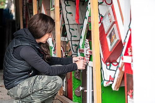 MIKAELA MACKENZIE / FREE PRESS
	
Jen de Delley re-glues items to the elf village&#x573; gym, which was damaged by a squirrel, in her carport workshop in River Heights on Monday, Nov. 18, 2024.

For AV story.
Winnipeg Free Press 2024