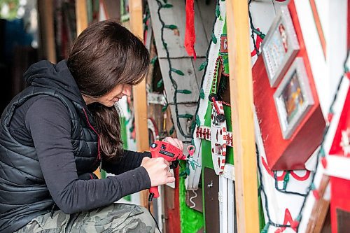 MIKAELA MACKENZIE / FREE PRESS
	
Jen de Delley re-glues items to the elf village&#x573; gym, which was damaged by a squirrel, in her carport workshop in River Heights on Monday, Nov. 18, 2024.

For AV story.
Winnipeg Free Press 2024