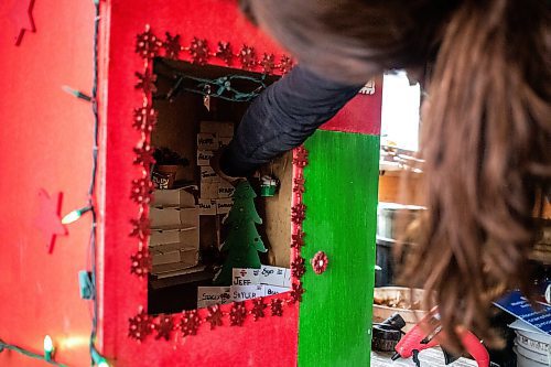 MIKAELA MACKENZIE / FREE PRESS
	
Jen de Delley replaces items in the elf village post office, which the squirrel made a mess of, in her carport workshop in River Heights on Monday, Nov. 18, 2024.

For AV story.
Winnipeg Free Press 2024