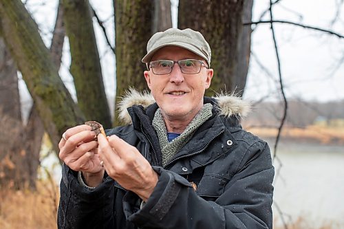 BROOK JONES/FREE PRESS
Poet and writer Bertrand Nayet reaches holds out a poem he wrote on birch bark and hung with flax thread from a branch of a linden tree at &#xce;le Pollock Park in 2019. Nayet was pictured in St. Norbert, Man., Tuesday, Nov. 19, 2024.