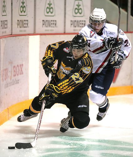 Brandon Wheat Kings forward Andrew Clark (27) loses his balance as he is chased into the corner by Tri-City Americans forward Johnny Lazo (21) during a 5-1 Wheat Kings win on Oct. 10, 2008 in Brandon. It was the last time Brandon beat Tri-City at home. (Brandon Sun file photo)