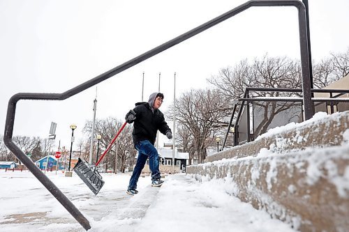 20112024
Nathaniel Delbridge shovels snow from the steps of the Western Manitoba Centennial Auditorium on Wednesday after a winter storm blanketed westman in snow and ice overnight. 
(Tim Smith/The Brandon Sun)