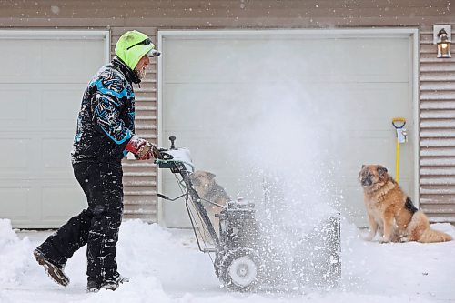 20112024
Trysten Jefferies uses a snowblower to clear snow from the driveway of his home in Souris as his dogs Argon and Heli look on during flurries on Wednesday afternoon. An overnight winter storm blanketed Westman in snow.  (Tim Smith/The Brandon Sun)