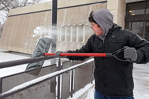 20112024
Nathaniel Delbridge shovels snow from the steps of the Western Manitoba Centennial Auditorium on Wednesday after a winter storm blanketed westman in snow and ice overnight. 
(Tim Smith/The Brandon Sun)