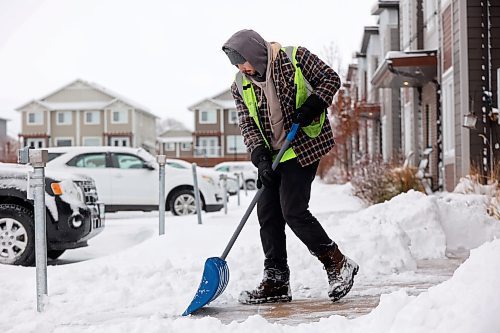 20112024
Cole Inwood clears sidewalks at The Groves in Brandon&#x2019;s south end on Wednesday after a winter storm blanketed westman in snow and ice overnight. 
(Tim Smith/The Brandon Sun)