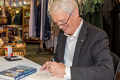 BROOK JONES/FREE PRESS
McNally Robinson hosts a special evening with Marc Garneau featuring a conversation hosted by Free Press Editor Paul Samyn in Winnipeg, Man., Wednesday, Nov. 20, 2024. Pictured: Canada's first man in space Garneau autographs a copy of his memoir A Most Extraordinary Ride: Space, Politics, and the Pursuit of a Canadian Dream published in early October of 2024 by McClelland &amp; Stewart.