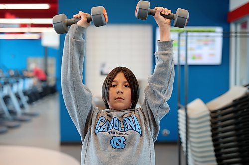 École New Era School Grade 5 student Jaxon Ferland works out with weights at the YMCA of Brandon during a YMCA Enrichment Program noon-hour workout with other New Era students on Thursday. (Photos by Tim Smith/The Brandon Sun)