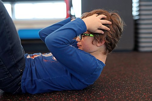 21112024
&#xc9;cole New Era School grade three student Benson Lyne does crunches at the YMCA of Brandon during a YMCA Enrichment Program noon-hour workout with other New Era students on Thursday. The pilot program currently involves 8 students from New Era ranging from grades 2-8 and is meant for students who benefit from more movement and activity throughout their school day. New Era counsellor Karl McDaniel and french immersion teachers Louise Roberts and Ellen Murray accompany the students to the YMCA three days a week and go through workouts with the kids.  (Tim Smith/The Brandon Sun)