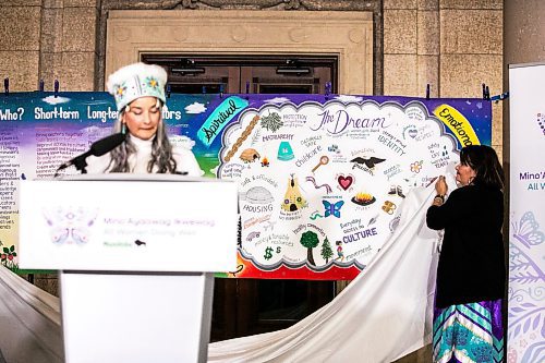 MIKAELA MACKENZIE / FREE PRESS
	
Cora Morgan helps unveil a banner as families minister Nahanni Fontaine speaks at the launch of the provincial strategy to empower Indigenous women, girls and gender-diverse relatives at the Manitoba Legislative Building on Friday, Nov. 22, 2024. 


Winnipeg Free Press 2024