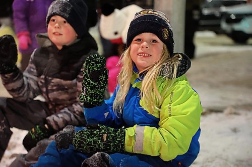 Five year old Hayes Bennett (right) and his brother Easton found a perfect spot on Princess Avenue to watch the Brandon Santa Parade Saturday evening. (Michele McDougall/The Brandon Sun) 
