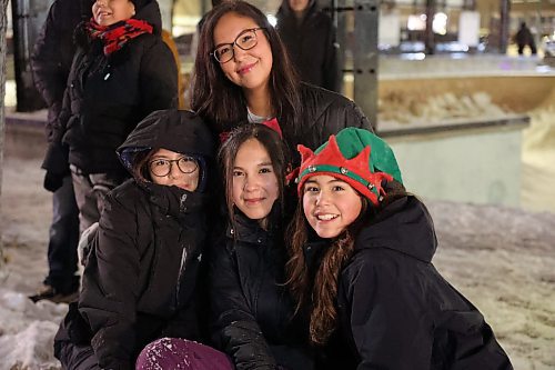 Nora Moose (in back) is all smiles as are her family members, Sadie (far left), Summer and Katie, as they watch the Brandon Santa Parade Saturday evening from their spot on Princess Avenue. (Michele McDougall/The Brandon Sun) 
