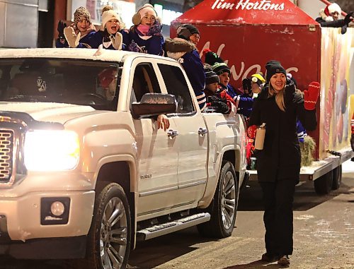 A participant with the Tim Horton's float walks down Rosser Avenue waving to the crowd during the Brandon Santa Parade Saturday evening. (Michele McDougall/The Brandon Sun) 