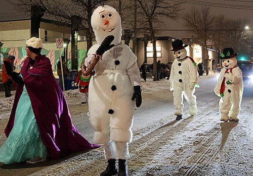 Some of the characters from "Frozen" walk along Princess Avenue during the 2024 Brandon Santa Parade Saturday evening. (Michele McDougall/The Brandon Sun) 
