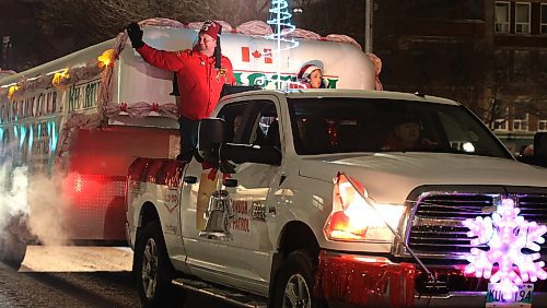 A member of the Brandon Shrine Club waves to the crowd during the 2024 Brandon Santa Parade Saturday evening with the route going down Rosser and then Princess Avenues. (Michele McDougall/The Brandon Sun) 
