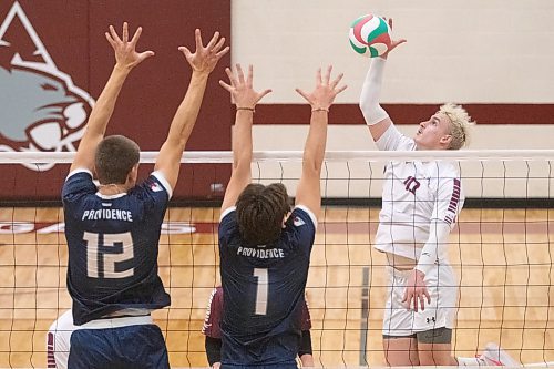 Noah Barcellona hits against the Providence Pilots block on Saturday afternoon. The Cougars went a full five sets on Friday but were swept Saturday at Assiniboine College Gym. (Matt Packwood/The Brandon Sun)