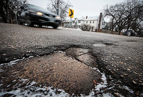 JOHN WOODS / FREE PRESS
A pothole on Waverly Street Sunday, November 24, 2024. 

Reporter: scott