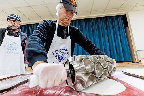 MIKE DEAL / FREE PRESS
Iyvan Michalchyshyn (left) watches his brother Joe Michalchyshyn (right) roll a custom made cutter across a sheet of dough.
St. Joseph's Ukrainian Catholic Church (250 Jefferson Ave) perogie &quot;bee,&quot; which has been going on for years, ahead of the holidays.
A group of volunteers who've been making perogies for eons, in the basement of the church, pinching perogies that will go on sale the following week.
Reporter: David Sanderson
241120 - Wednesday, November 20, 2024.