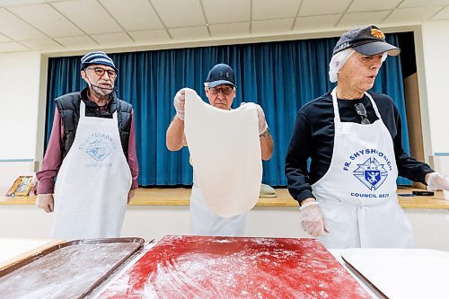 MIKE DEAL / FREE PRESS
Ron Lukie delivers a sheet of dough for the cutters, Iyvan Michalchyshyn (left) and his brother Joe Michalchyshyn (right).
St. Joseph's Ukrainian Catholic Church (250 Jefferson Ave) perogie &quot;bee,&quot; which has been going on for years, ahead of the holidays.
A group of volunteers who've been making perogies for eons, in the basement of the church, pinching perogies that will go on sale the following week.
Reporter: David Sanderson
241120 - Wednesday, November 20, 2024.