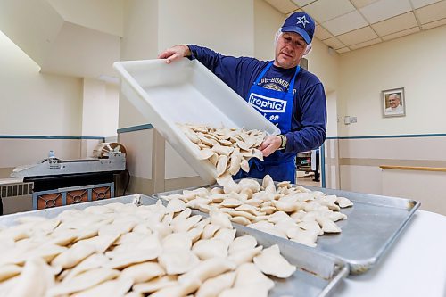 MIKE DEAL / FREE PRESS
Michael Hrechka delivers a batch of cooked and cooled perogies to the next station for quality control and packaging.
St. Joseph's Ukrainian Catholic Church (250 Jefferson Ave) perogie &quot;bee,&quot; which has been going on for years, ahead of the holidays.
A group of volunteers who've been making perogies for eons, in the basement of the church, pinching perogies that will go on sale the following week.
Reporter: David Sanderson
241120 - Wednesday, November 20, 2024.