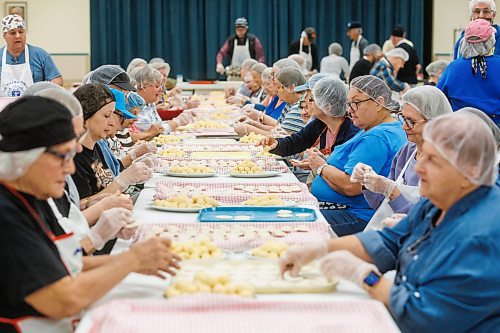 MIKE DEAL / FREE PRESS
Volunteers sit at a long row of tables pinching perogies.
St. Joseph's Ukrainian Catholic Church (250 Jefferson Ave) perogie &quot;bee,&quot; which has been going on for years, ahead of the holidays.
A group of volunteers who've been making perogies for eons, in the basement of the church, pinching perogies that will go on sale the following week.
Reporter: David Sanderson
241120 - Wednesday, November 20, 2024.