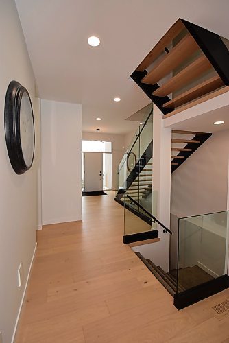 Todd Lewys / Free Press
A gorgeous open-riser staircase bordered by tempered glass inserts endows the foyer with a wonderful dash of style.