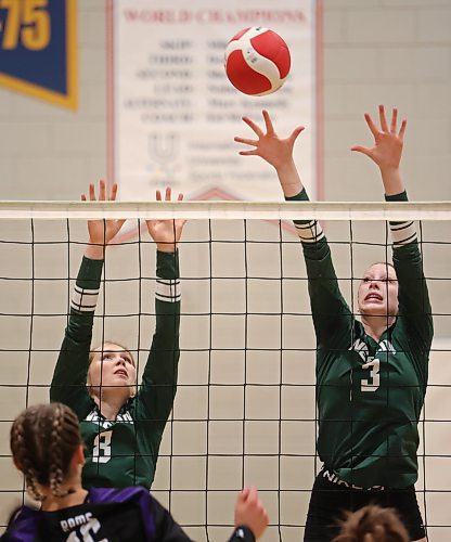 Gracie Blatherwick (8) and Avery Black (3) of the Neelin Spartans leap to block the ball during Spartan Dig earlier this season. (Tim Smith/The Brandon Sun)