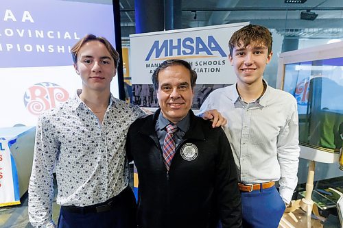 MIKE DEAL / FREE PRESS
Gabrielle-Roy Les Roys boys volleyball team members, Martin de Moissac (left) and Alek Ouimet (right) along with Coach Michel Lavergne at the schedule announcement for the 2024&#xa0;Boston Pizza AAAA Provincial Volleyball Championships at the Manitoba Sports Hall of Fame (145 Pacific Avenue) Tuesday afternoon.
Reporter: Mike Sawatzky
241126 - Tuesday, November 26, 2024.