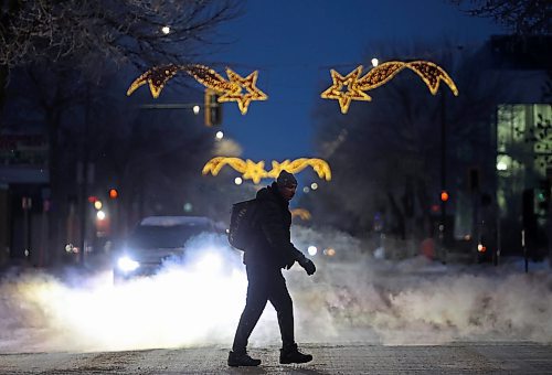 26112024
A pedestrian makes their way across Princess Avenue in downtown Brandon at dusk as the Christmas lights above the avenue glow on Tuesday.
(Tim Smith/The Brandon Sun)