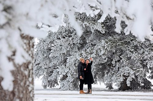 27112024
Hilary Macalanda and Katherine Mansoy take photos together amongst the hoar-frost covered trees at the Brandon Research and Development Centre off Grand Valley Road on a crisp Wednesday morning. 
(Tim Smith/The Brandon Sun)