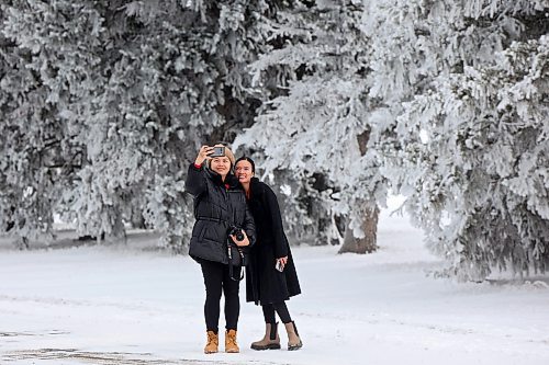 27112024
Hilary Macalanda and Katherine Mansoy take photos together amongst the hoar-frost covered trees at the Brandon Research and Development Centre off Grand Valley Road on a crisp Wednesday morning. 
(Tim Smith/The Brandon Sun)