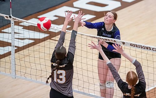 BROOK JONES/FREE PRESS
The Vincent Massey (Brandon) Vikings earned a victory over the Steinbach Sabres in the semi-finals (final four) of the Boston Pizza AAAA Varisty Girls Volleyball Championships hosted by the Maintoba High Schools Athletic Association inside Investors Group Athletic Centre at the University of Manitoba Fort Garry campus in Winnipeg, Man., Wednesday, Nov. 27, 2024. With the win, the Vikings will compete in the MHSAAA provincial volleyball championships at IGAC Monday, Dec. 2, 2024. Pictured: Vincent Massey Vikings setter Payton Oakden spikes the volleyball as Steinbach Sabres outside hitter (No. 13) and Sabres teammate middle Callie Andres go up for the block during third set action.