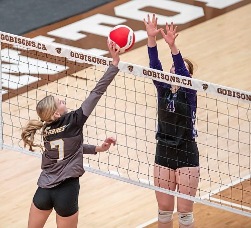 BROOK JONES/FREE PRESS
he Vincent Massey (Brandon) Vikings earned a victory over the Steinbach Sabres in the semi-finals (final four) of the Boston Pizza AAAA Varisty Girls Volleyball Championships hosted by the Maintoba High Schools Athletic Association inside Investors Group Athletic Centre at the University of Manitoba Fort Garry campus in Winnipeg, Man., Wednesday, Nov. 27, 2024. With the win, the Vikings will compete in the MHSAAA provincial volleyball championships at IGAC Monday, Dec. 2, 2024. Pictured: Steinbach Sabres outside hitter Kiersten Reimer (No. 7) taps the volleyball over the net as Vincent Massey Vikings right side/left side Zoe Price (No. 4) goes up for the block during third set action.