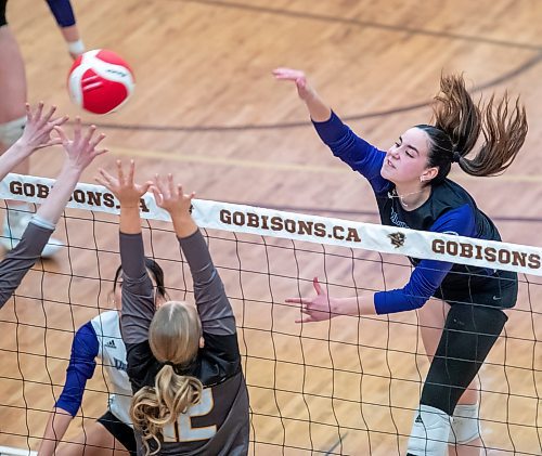 BROOK JONES/FREE PRESS
he Vincent Massey (Brandon) Vikings earned a victory over the Steinbach Sabres in the semi-finals (final four) of the Boston Pizza AAAA Varisty Girls Volleyball Championships hosted by the Maintoba High Schools Athletic Association inside Investors Group Athletic Centre at the University of Manitoba Fort Garry campus in Winnipeg, Man., Wednesday, Nov. 27, 2024. With the win, the Vikings will compete in the MHSAAA provincial volleyball championships at IGAC Monday, Dec. 2, 2024. Pictured: Vincent Massey Vikings left side Hannah McGregor (No. 13) spikes the volleyball as Steinbach Sabres setter Abigail Voth (No. 12) goes up for the block while Vikings middle Kypling Black (No. 5) keeps an eye on the volleyball during third set action.