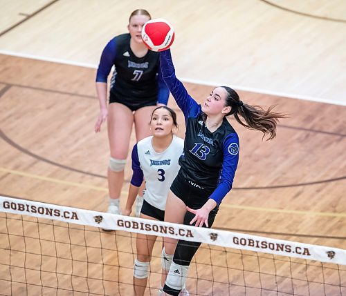 BROOK JONES/FREE PRESS
he Vincent Massey (Brandon) Vikings earned a victory over the Steinbach Sabres in the semi-finals (final four) of the Boston Pizza AAAA Varisty Girls Volleyball Championships hosted by the Maintoba High Schools Athletic Association inside Investors Group Athletic Centre at the University of Manitoba Fort Garry campus in Winnipeg, Man., Wednesday, Nov. 27, 2024. With the win, the Vikings will compete in the MHSAAA provincial volleyball championships at IGAC Monday, Dec. 2, 2024. Pictured: Vincent Massey Vikings left side Hannah McGregor (No. 13) spikes the volleyball as vikings teammates libero Georgia Hall (No. 3) and left side Jersey Hansen-Young (No. 7) keep an eye on the volleyball during third set action.