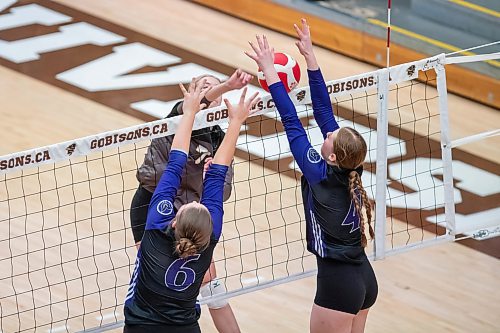 BROOK JONES/FREE PRESS
he Vincent Massey (Brandon) Vikings earned a victory over the Steinbach Sabres in the semi-finals (final four) of the Boston Pizza AAAA Varisty Girls Volleyball Championships hosted by the Maintoba High Schools Athletic Association inside Investors Group Athletic Centre at the University of Manitoba Fort Garry campus in Winnipeg, Man., Wednesday, Nov. 27, 2024. With the win, the Vikings will compete in the MHSAAA provincial volleyball championships at IGAC Monday, Dec. 2, 2024. Pictured: Steinbach Sabres outside hitter Kiersten Reimer (No. 7) spikes the volleyball as Vincent Massey Vikings middle Ashley Sullivan (No. 6) and Vikings teammate right side/left side Zoe Price (No. 4) go up for the block during second set action.