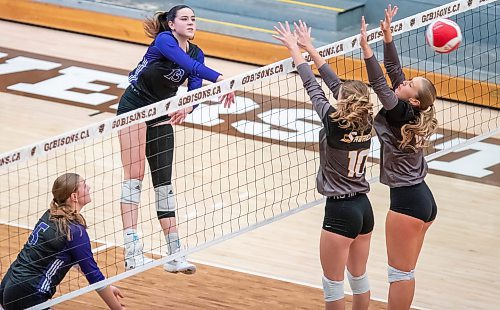 BROOK JONES/FREE PRESS
he Vincent Massey (Brandon) Vikings earned a victory over the Steinbach Sabres in the semi-finals (final four) of the Boston Pizza AAAA Varisty Girls Volleyball Championships hosted by the Maintoba High Schools Athletic Association inside Investors Group Athletic Centre at the University of Manitoba Fort Garry campus in Winnipeg, Man., Wednesday, Nov. 27, 2024. With the win, the Vikings will compete in the MHSAAA provincial volleyball championships at IGAC Monday, Dec. 2, 2024. Pictured: Vincent Massey Vikings left side Hannah McGregor (No. 13) spikes the volleyball as Steinbach Sabres middle Olivia Unrau (No. 10) and Sabres teammate setter Abigail Voth (No. 12) attempt the block while Vikings middle Kypling Black (No. 5) keeps an eye on the volleyball during second set action.