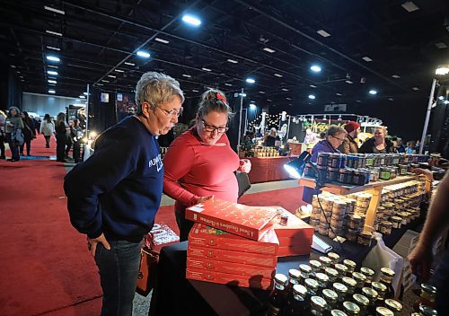 RUTH BONNEVILLE / FREE PRESS
Standup Christmas Craft Sale
Dawn English looks at a Advent Calendar with little jars of specialty jam in each window with her daughter Mahalia Budzinski at the Beary Berry Honey Booth while visiting Winnipeg's Christmas Market Thursday.
Winnipegճ Largest Christmas Market is jam-packed full of things to see and do including: 125+ ARTISAN POP-UP SHOPS, live music, festive workshops, Mock-tail making, food trucks and food tastings. It runs from Thurs. Nov 28th until Sun. Dec 1st at the RBC Convention Centre.
Nov 28th, 2024