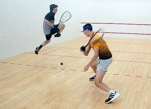 Leyton Gouldie of Brandon eyes a shot as Christian Pocsai leaps clear of the ball in the fifth place match of the Brandon Classic, a Racquetball Canada national team selection event held at the Sportsplex over the weekend. (Matt Packwood/The Brandon Sun)