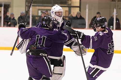 Vikings goaltender Landon McGregor is greeted by teammates following the final buzzer in the concluding game of Sunday's Victoria Inn high school hockey tournament. (Matt Packwood/The Brandon Sun)