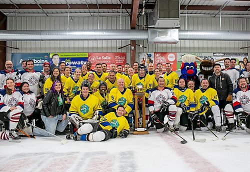 BROOK JONES/FREE PRESS
The City of Winnipeg and the Province of Manitoba rekindled a half-century old hockey rivalry at Gateway Recreation Centre in Winnipeg, Man., Saturday, Nov. 30, 2024. The friendly hockey game between politicans, Winnipeg's public service and provincial staff was held in celebration of Winnipeg's 150th anniversary. Pictured: Members of the Winnipeg 150 hockey team and the Province hockey team gather around the championship trophy which was first presented 50 years ago to the winning team when the city led by then mayor Stephen Juba took on the province led by then premier Edward Schreyer.