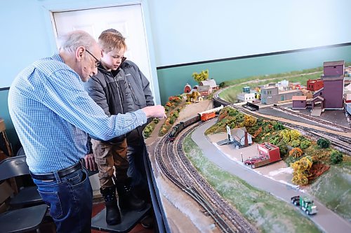 Left: Brandon Hills Model Railway Club member Bill McGuire tells James Smith, 7. about the HO Scale model layout on Saturday during the open house. (Abiola Odutola/The Brandon Sun)