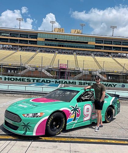 TAYLOR ALLEN / FREE PRESS
Taylor Allen poses with a race car at Homestead-Miami Speedway.