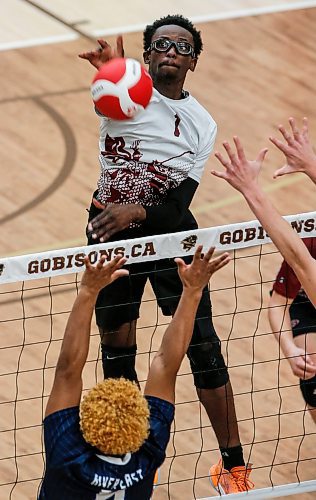 JOHN WOODS / WINNIPEG FREE PRESS
St Paul&#x2019;s Crusaders&#x2019; Funmi Sofoluwe (1) hits against River East Kodiaks&#x2019; Connor Freeman (6) in the Manitoba High School 2022 AAAA Varsity Volleyball Provincial Championship at the University of Manitoba Monday, December 2, 2024.