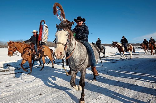 03122024
The Sioux Valley Dakota Nation Unity Riders lead the way to escort 11 bison (often referred to as buffalo in Dakota culture) through Birdtail Sioux First Nation to their new home in an enclosure in Birdtail&#x2019;s valley on Tuesday. The bison, including one white bison, were a gift to Birdtail from Sioux Valley. 
(Tim Smith/The Brandon Sun)