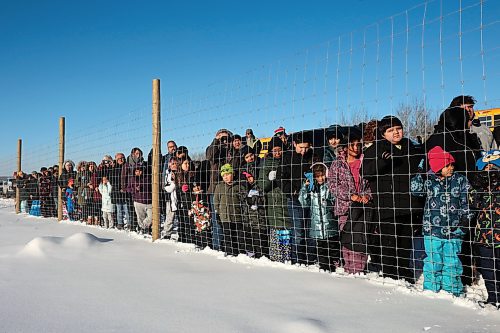 03122024
Community members crowd around the bison enclosure at Birdtail Sioux First Nation to watch as 11 bison, including one white bison, gifted to Birdtail by Sioux Valley Dakota Nation are released into their new enclosure on Tuesday. White bison are considered sacred by many First Nations and bison as a whole hold special cultural and spiritual significance. The bison were escorted through the community by the Sioux Valley Dakota Nation Unity Riders.    (Tim Smith/The Brandon Sun)